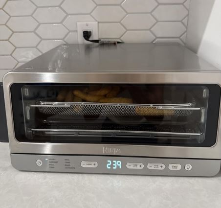 Ninja Air Fryer Toaster Oven Combo 8-in-1 Functionality Flip Up And Away for Storage Space Air Fry Basket Sheet Pan Wire Rack And Removable Crumb Tray 1800 Watt Stainless Steel SP151